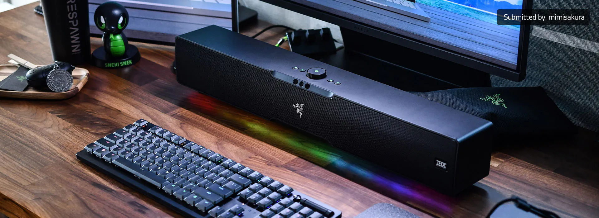 Razer Leviathan V2 Pro soundbar on a desk showing the top-mounted volume knob and head-tracking camera array