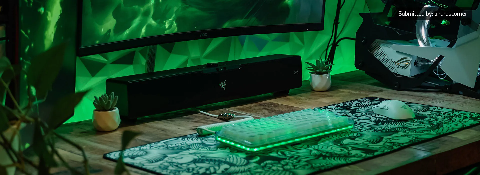 Angled view of the Razer Leviathan V2 Pro soundbar in black on a desk with green RGB accent lighting