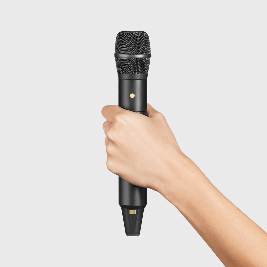 Hand holding the black Interview PRO around its central body with the antenna end uncovered