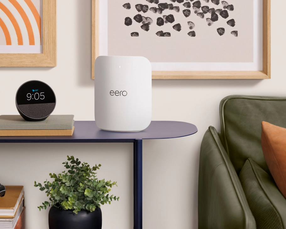 Amazon eero Max 7 unit placed on a console table in a living room, showing relative size and rounded-rectangle form factor