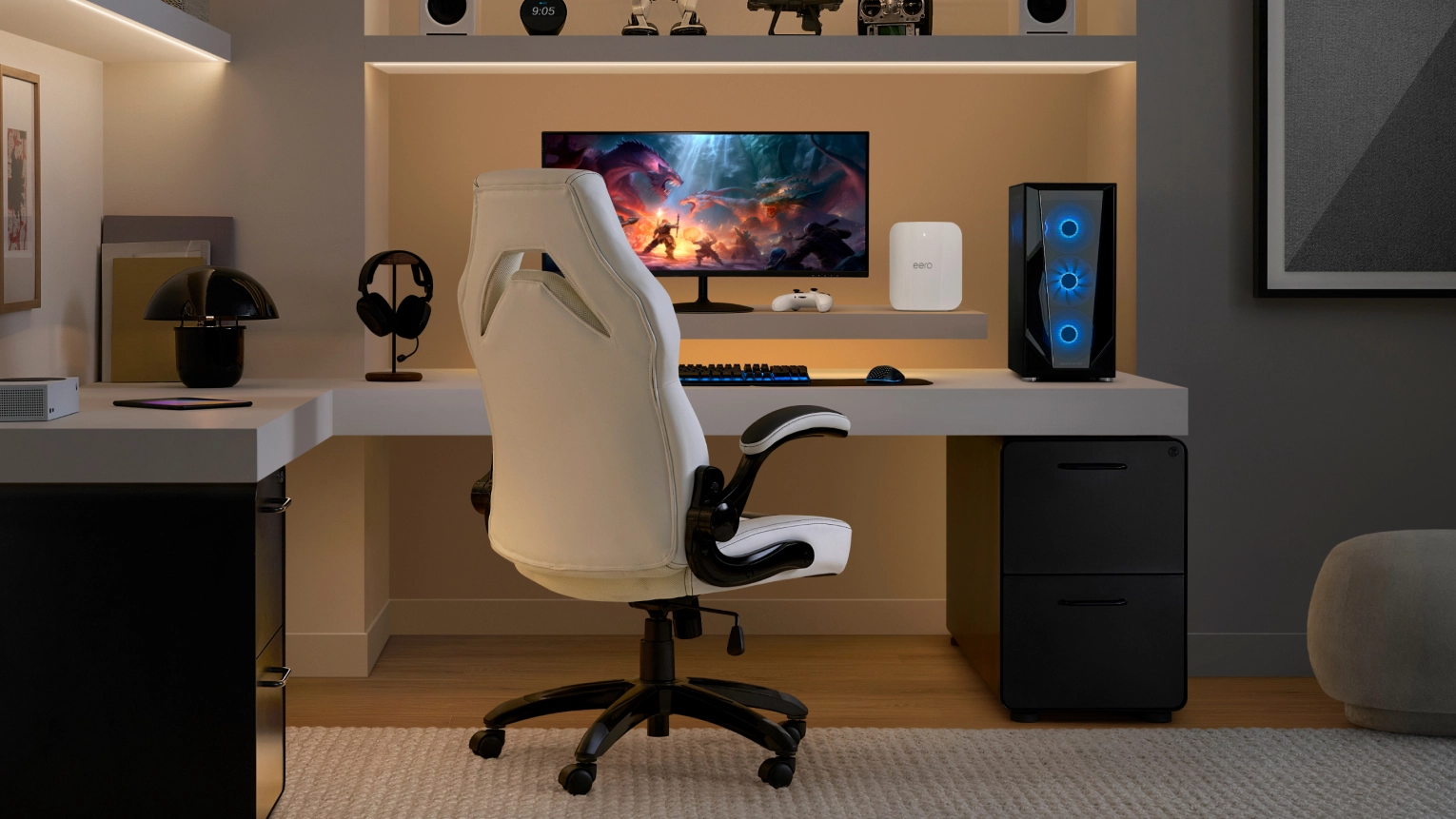 Amazon eero Max 7 unit on a shelf above a gaming desk setup with monitor, PC and peripherals